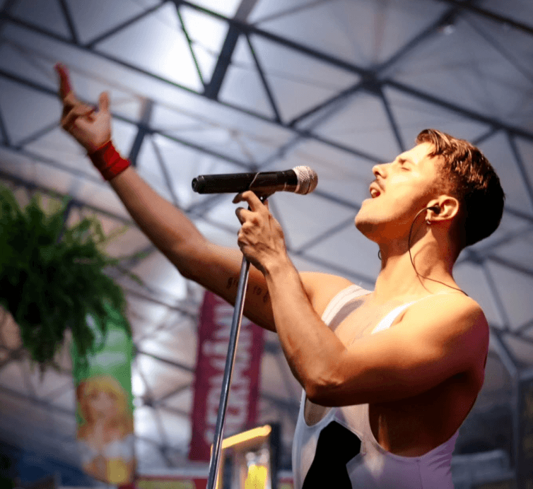 A dynamic shot of a rock band performing on stage, with the lead singer in a charismatic pose.